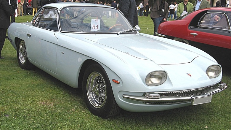 Lamborghini 350 GT coupe seen from front right parked outdoors at car show