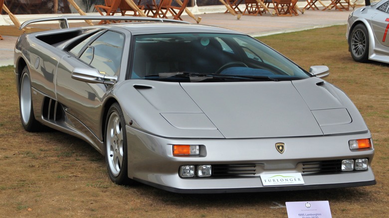 Silver Lamborghini Diablo SE30 seen from front right at Salon Prive 2022