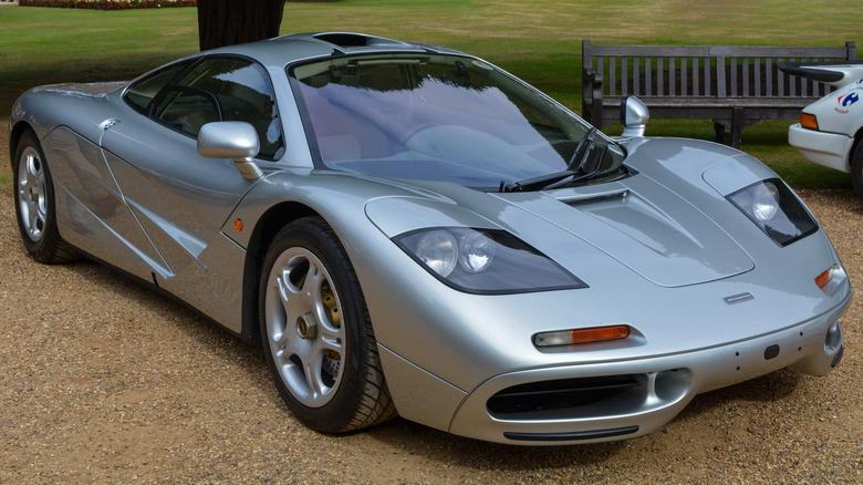 Silver 1996 McLaren F1 seen from front right parked outdoors at car show