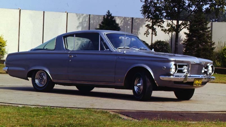 Blue first generation Plymouth Barracuda in driveway