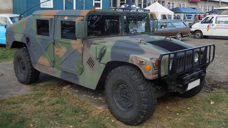 A HMMWV operated by the German Army parked in front of several buildings