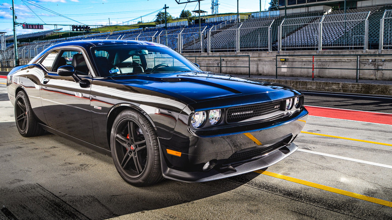 Front-right quarter view on a Black 2018 Challenger SRT Demon parked on a racetrack.