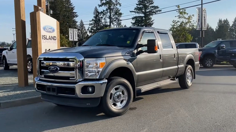 A side shot of a grey 2016 Ford F-250 parked