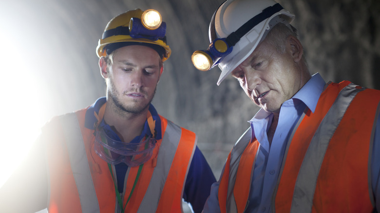 workers using head lamps