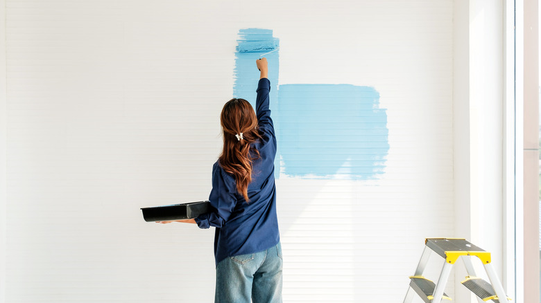 woman painting a wall