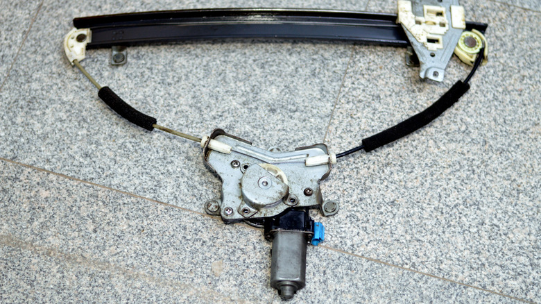 a window regulator assembly on the ground