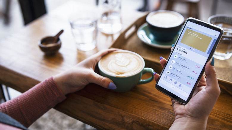 Woman checking mobile banking app 