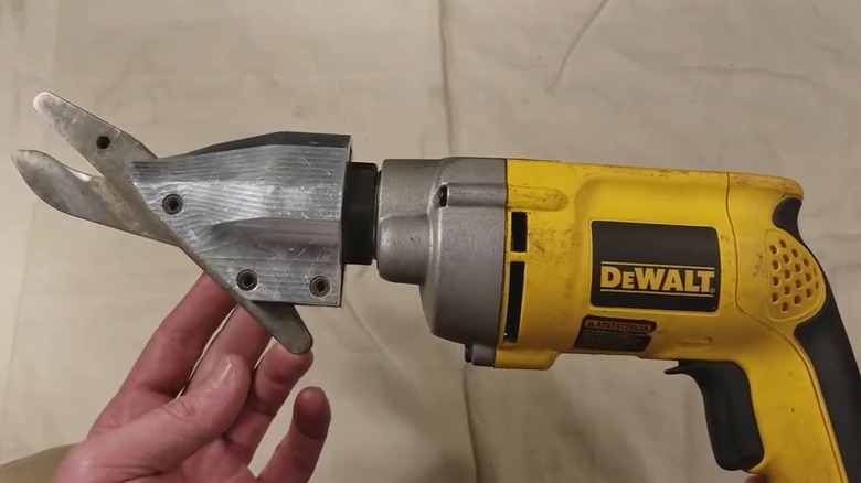 Person holding DeWalt cement shear