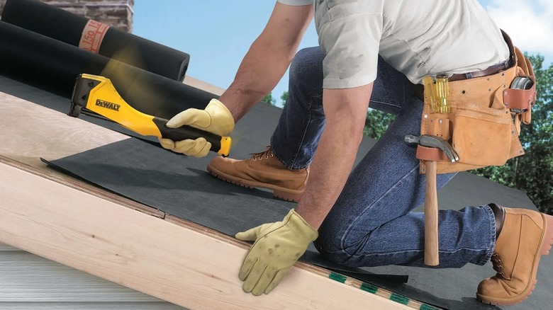Person using DeWalt hammer tacker