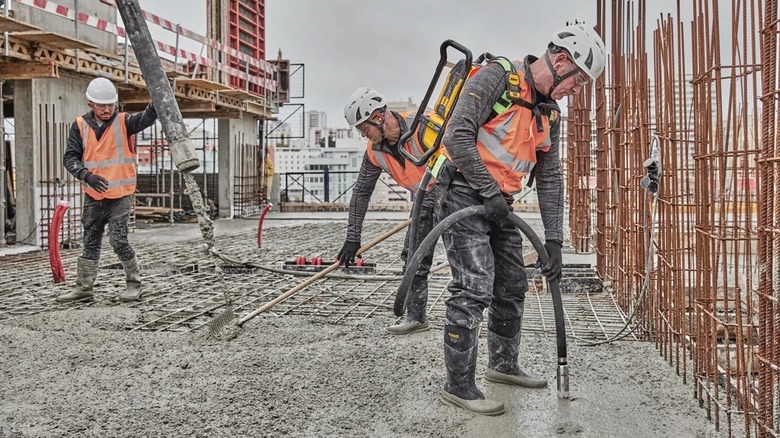 Person using concrete vibrator backpack