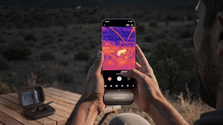 A man locating an animal at night.