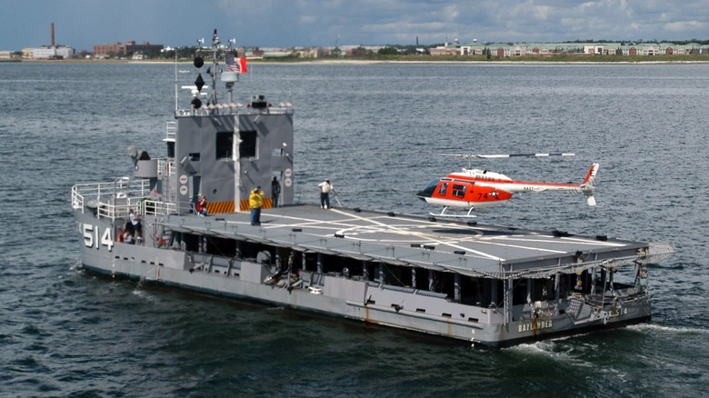 A helicopter practicing a landing on the Navy Helicopter Landing Trainer (HLT) IX-514