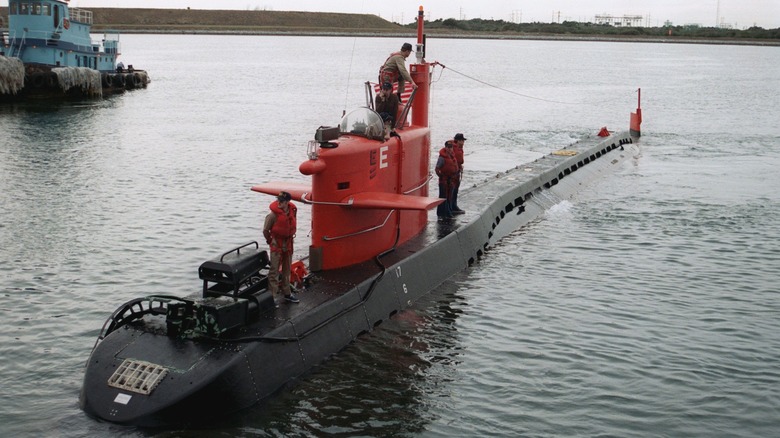 Several personnel atop the NR-1 submarine