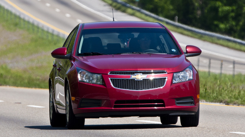 A Chevrolet Cruze, finished in black, on a podium at an auto show in Detroit in 2011.