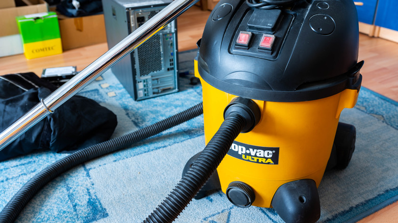 shop vac being used for home cleaning