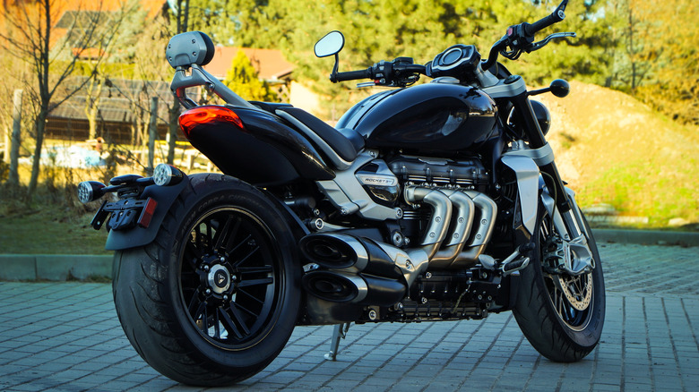 A current-generation Triumph Rocket 3 GT motorcycle finished in black and chrome parked on its kickstand.
