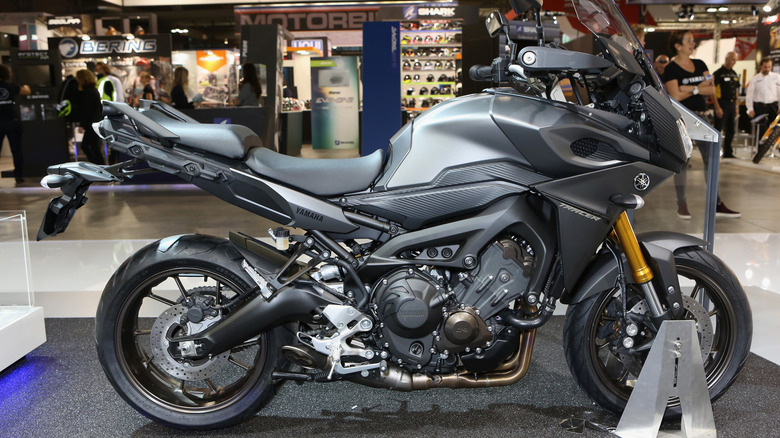 The larger version of the MT-07, which is the Yamaha MT-09, parked on an indoor pavilion at an exhibition.