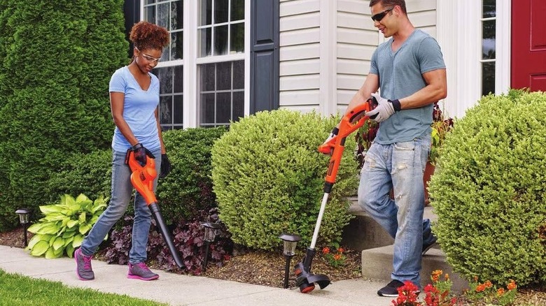 Man and woman using Black + Decker Trimmer/Edger and Sweeper