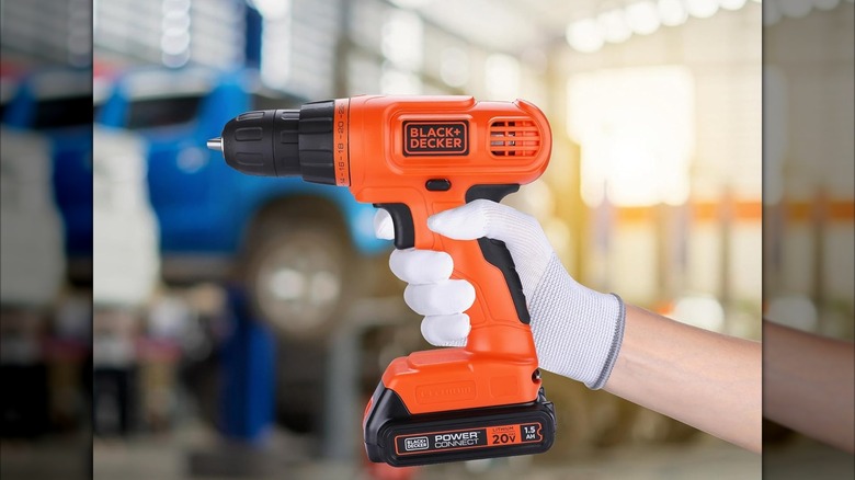 person holding black and decker drill