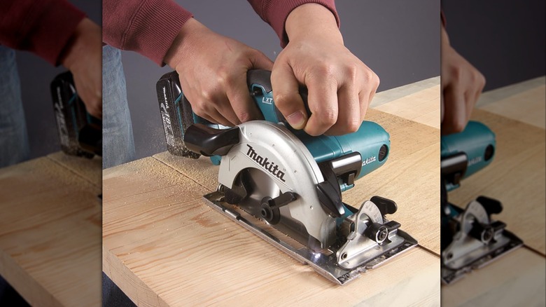 Person holding Makita circular saw