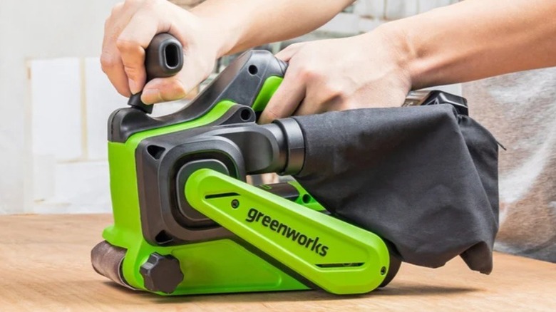 Person using Greenworks powered sander