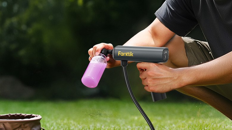 Person using Fanttik electric sprayer in yard