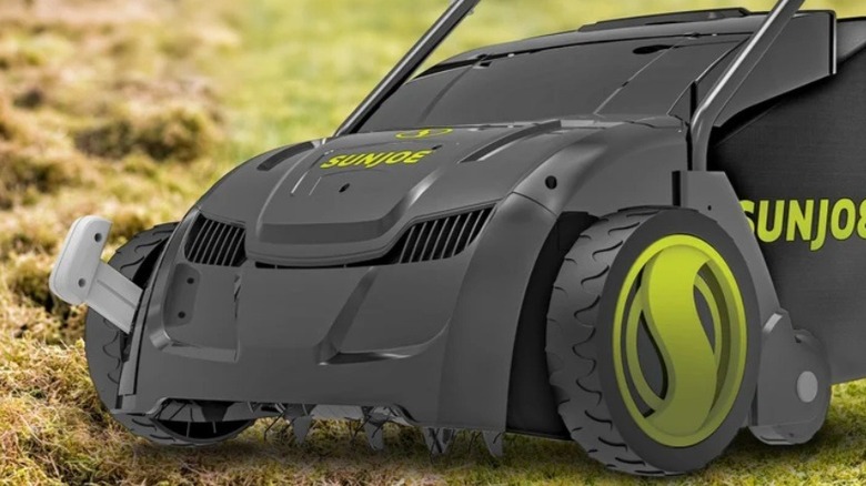 A Sun Joe lawn dethatcher being used.
