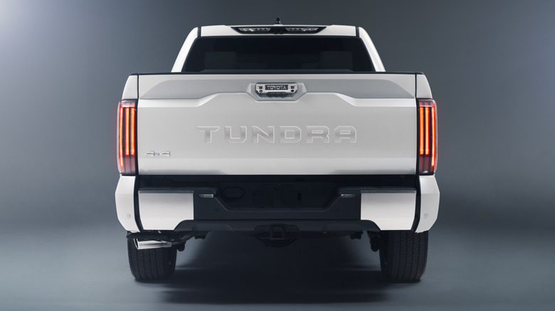 Rear end of white 2022 Toyota Tundra in a studio setting
