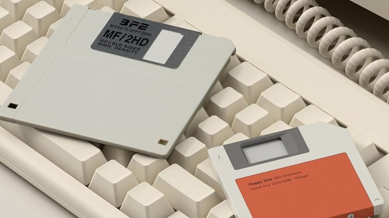 A pair of SSD enclosures designed like floppy disks on top of a keyboard