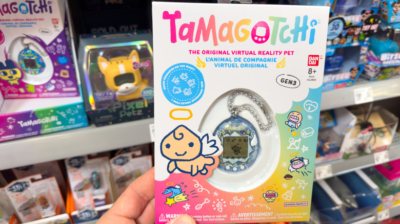 A modern Tamagotchi toy being held in a store