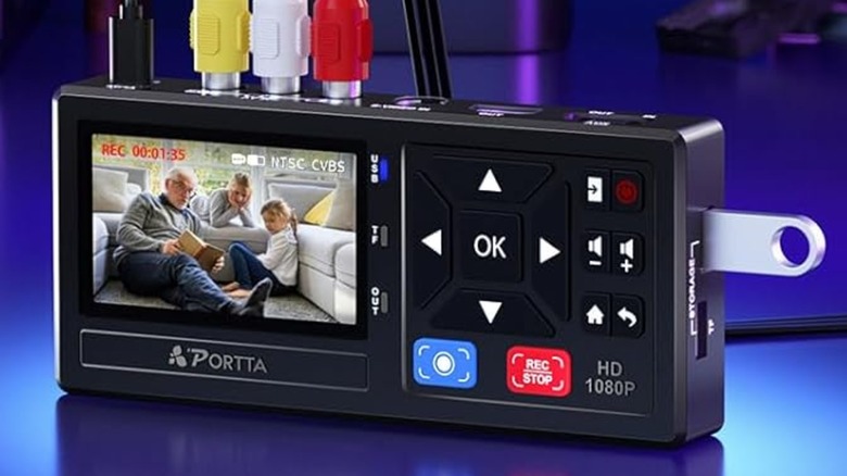 A VHS to digital converter with a USB drive and A/V plugs attached