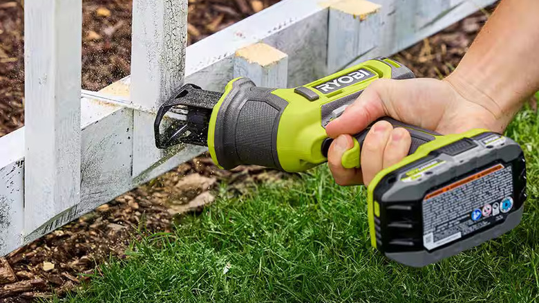 Ryobi one handed reciprocating saw cutting through fencing