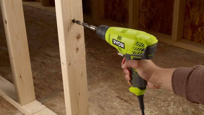 DIYer using a Ryobi corded drill