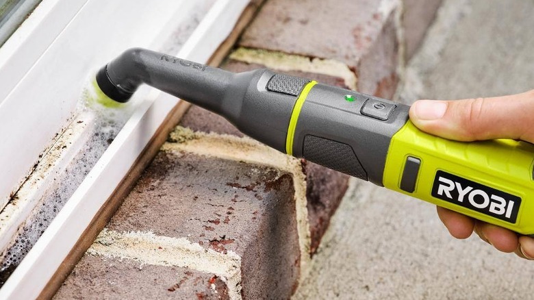 Ryobi detail scrubber cleaning inside a door frame