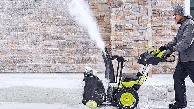 Person using Ryobi snow blower