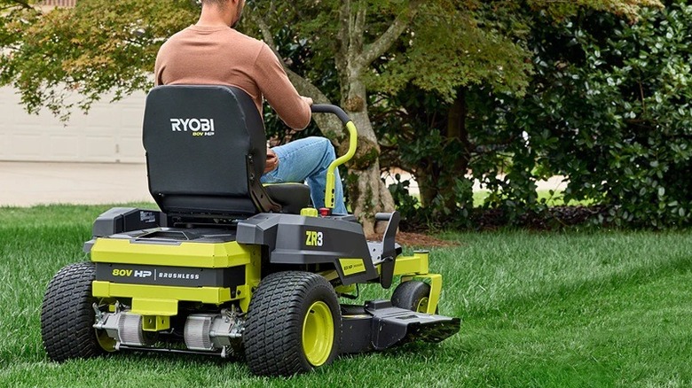 Person using Ryobi riding mower