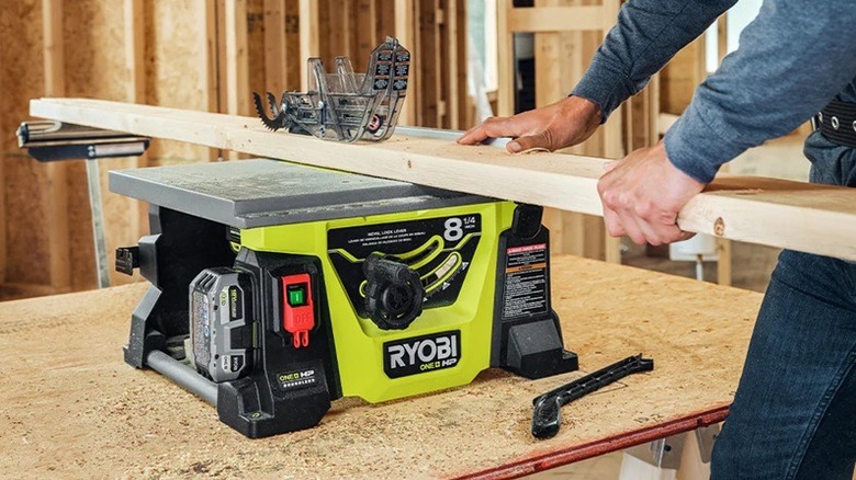 Person using Ryobi table saw