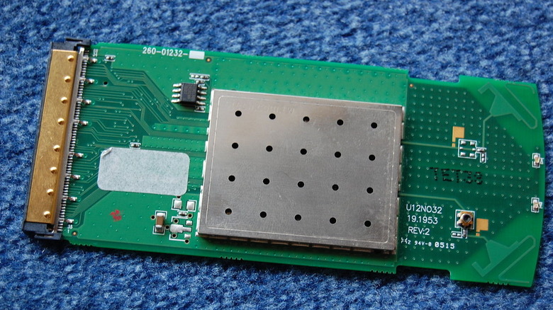 Green WLAN Card on a blue carpet surface