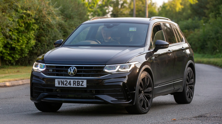 A right-side drive Volkswagen Tiguan leaning into a curve