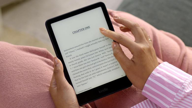 A woman holding a Kindle Paperwhite
