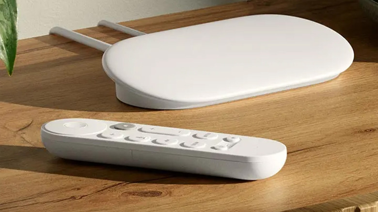 A Google TV Streamer device on a wood table