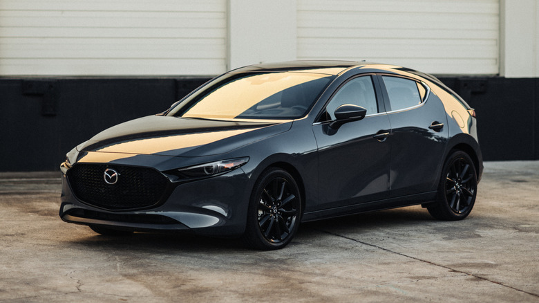 Mazda 3 near a warehouse