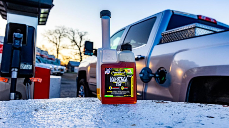 A B20 Biodiesel bottle on a table near a truck.