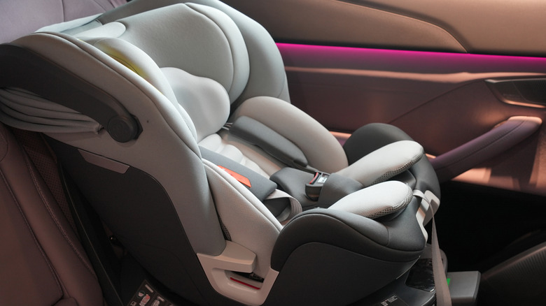 A baby car seat strapped into a car