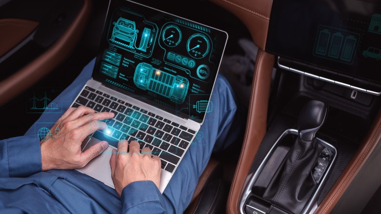 a person using a laptop in a car