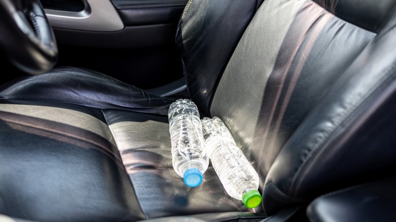 two water bottles placed on the driver seat