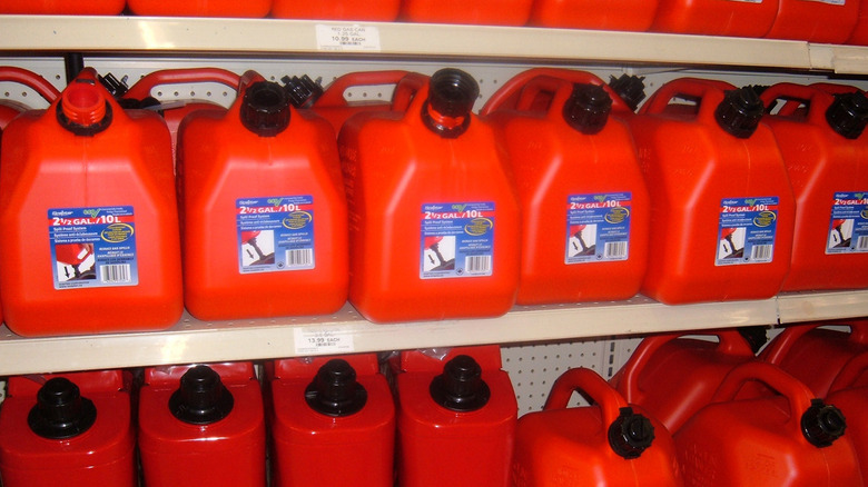 A shelf with gas cans on it