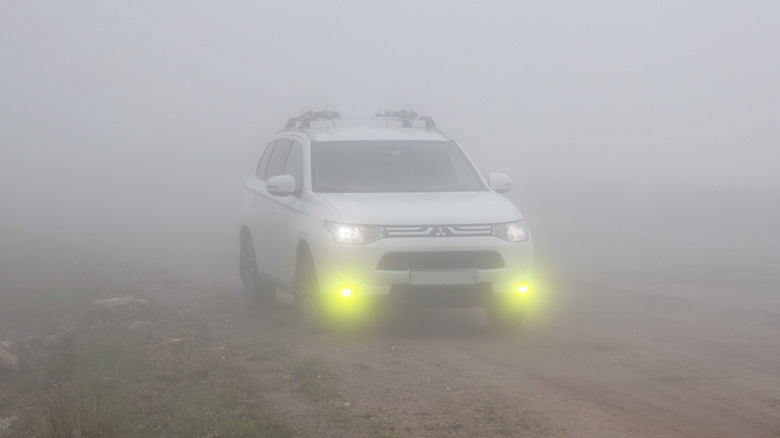 A white SUV with fog lights turned on