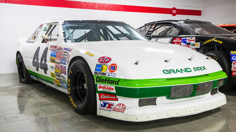 White and green No. 44 Pontiac Grand Prix NASCAR stock car with vintage sponsor decals and Goodyear tires.