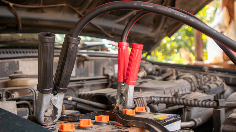Jump cables connected to a car battery